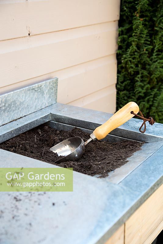 Tools and soil on potting bench 