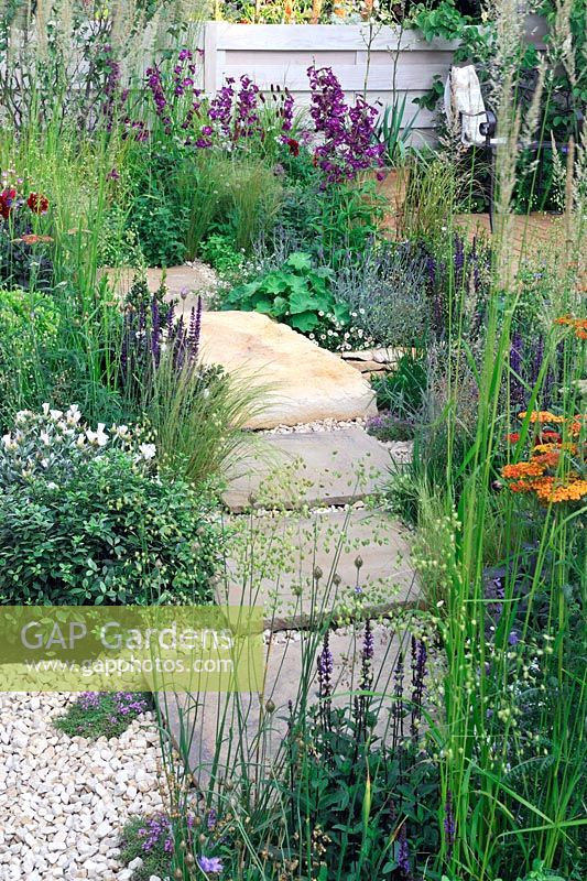 Stepping stones made from large irregular stone slabs - Four Corners Garden, RHS Hampton Court Flower Show 2013, Design -  Peter Reader