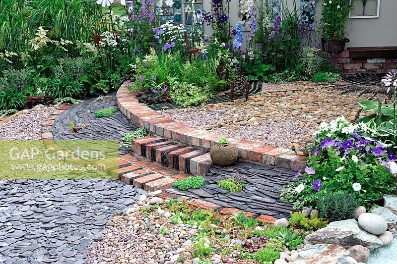 Semi circular patio using bricks, slate, gravel and pebbles. Garden Gallery. RHS Tatton Park Flower show 2013