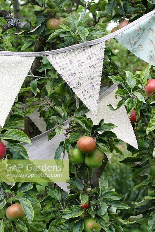 Step by step of making garden bunting - The finished bunting hanging in an apple tree