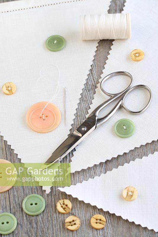 Step by step of making garden bunting with vintage linens and buttons - Make use of any plain areas of linen by sewing on old buttons