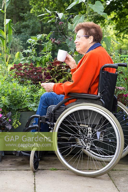 Elderly disabled woman enjoying a cup of tea