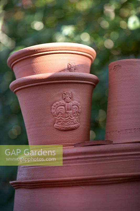 Hand thrown terracotta pots with crown design.