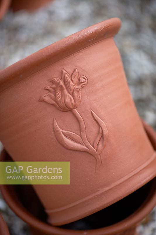 Hand thrown terracotta pot with tulip design.