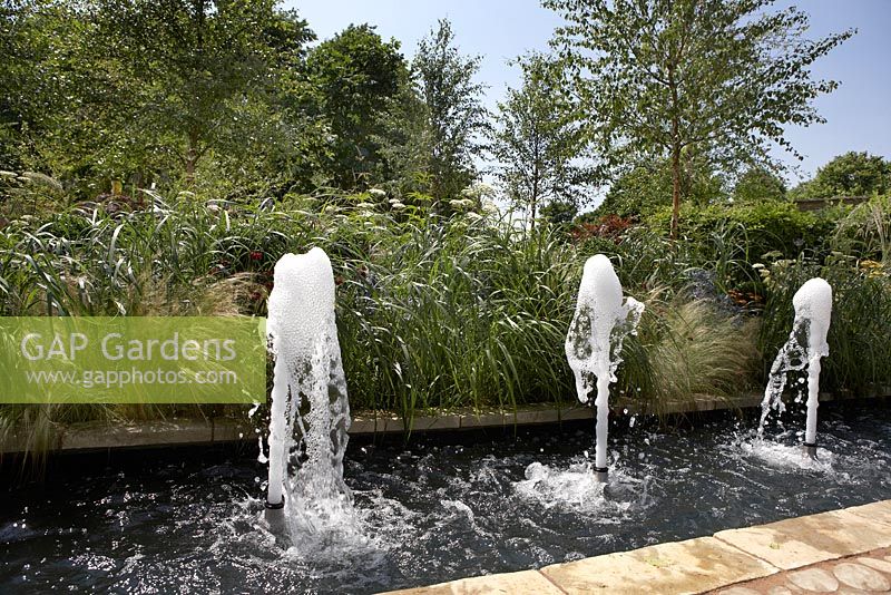 Fountains in small pool. 'The QEF Garden for Joy'. Sponsor -  Queen Elizabeth's Foundation for Disabled People.  RHS Hampton Court Flower Show 2013.