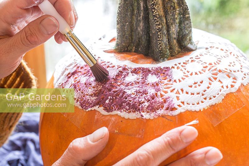 Using a stencil to paint a pattern onto a Pumpkin