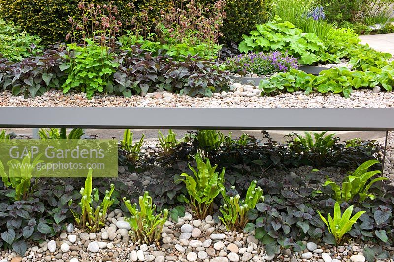 Split level gravel garden with mirrored panels in The First Touch Garden at RHS Chelsea Flower Show 2013