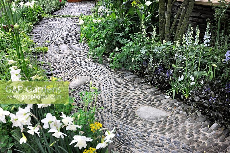 Pebble paved path and flowering borders in the Get Well Soon garden