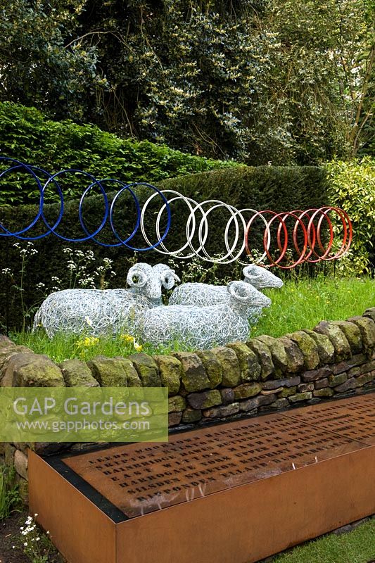 Le Jardin de Yorkshire garden - wire mesh sheep and bicycle wheel sculpture, dry stone wall and corten rusted steel water trough 