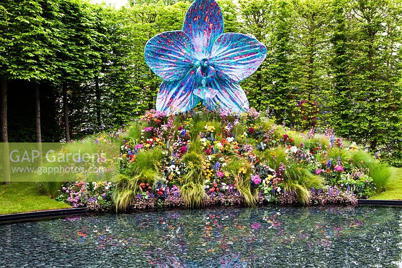 'The Rush of Nature' with orchid sculpture and gnomes painted by various celebrities 