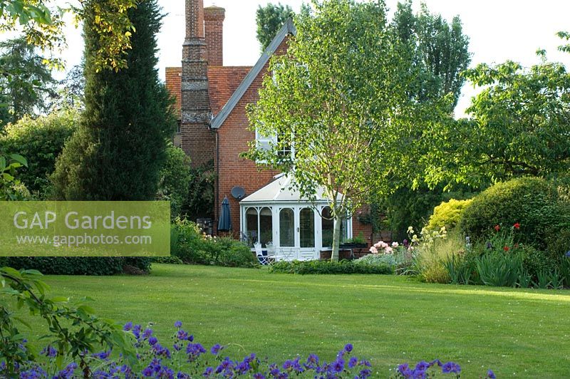 House and conservatory viewed across lawn 