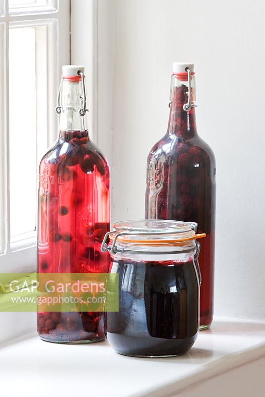 Home grown preserves in glass bottles and a jar