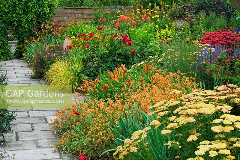 The Lanhydrock garden with Achillea 'Terracotta', Erysimum 'Apricot delight', Hemerocallis 'Anzac' and Rosa Frensham 