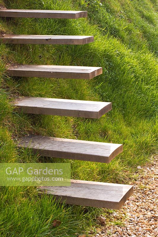Wooden steps set into grassy hillside. 