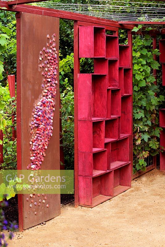 Pergola made of red painted wineboxes and winecork decoration. 