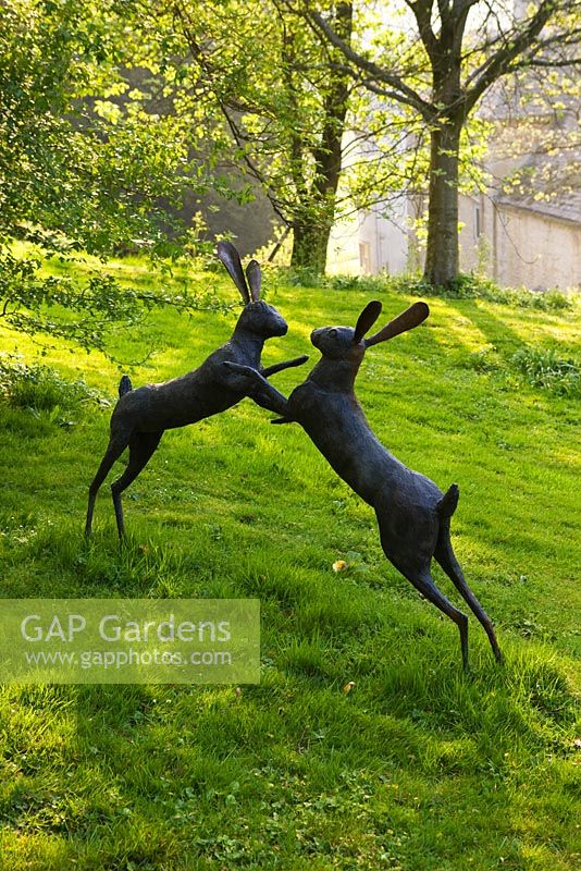 Cerney House Garden. Sculpture of boxing hares 
