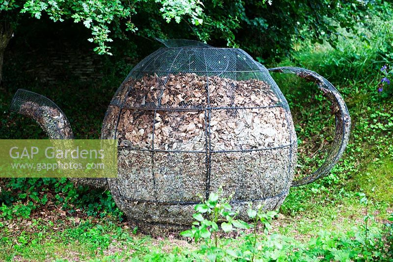 Compost heap in shape of tea-pot - The West Garden, Daglingworth House, Gloucestershire, UK. June.