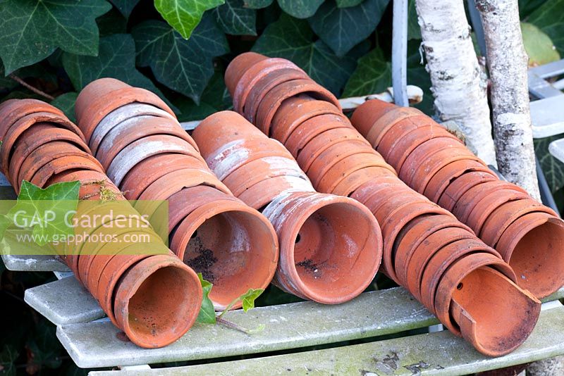 Used terracotta pots on a chair