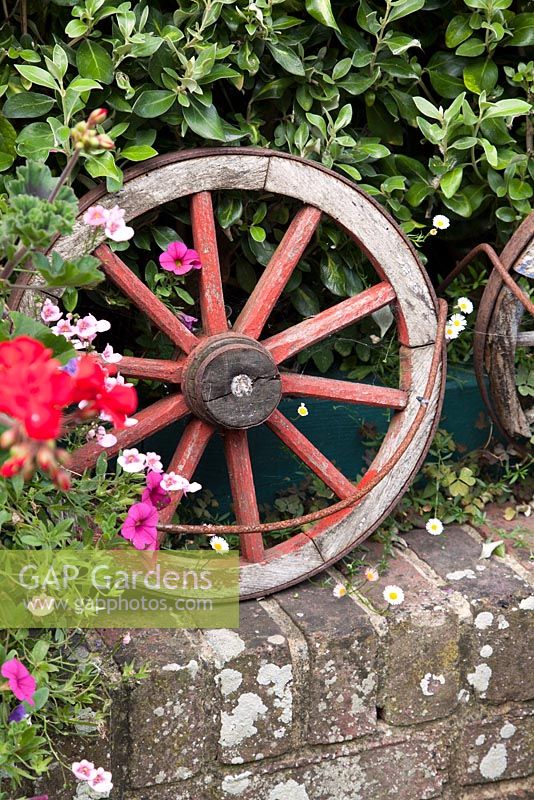 Decorative rustic wooden wheel on wall