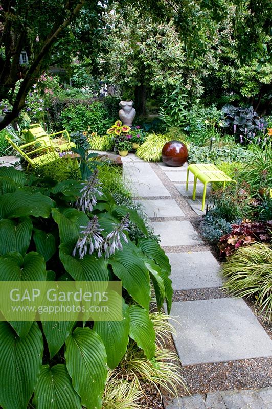 Path and Summer border with Hosta, view to seating area.