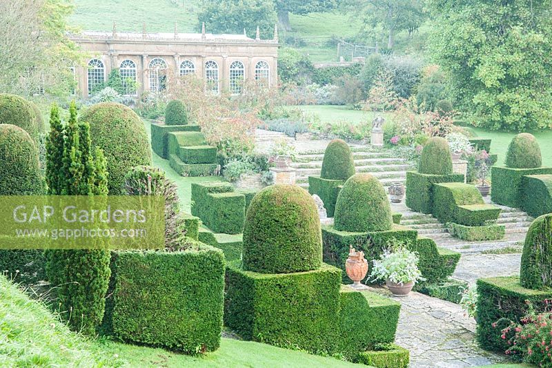 The Italianate Fountain Court, set out by Ethel Labouchere in the 1920s, features clipped yews, stone lions and eagles, and a central fountain. Mapperton House, Beaminster, Dorset, UK