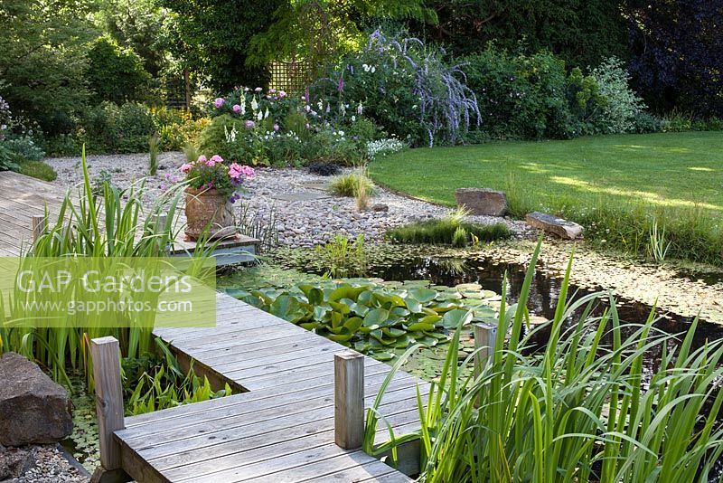 Pond with wooden decking path across