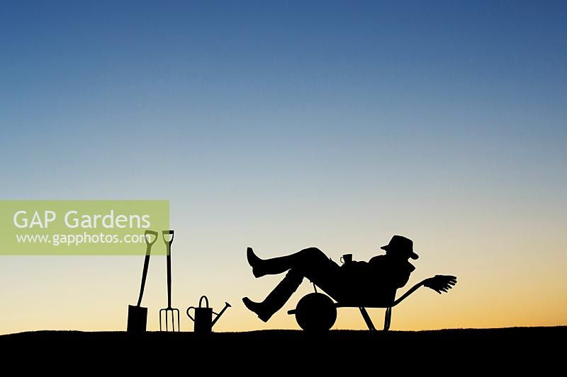 Gardener resting with a mug of tea in a wheelbarrow silhouette