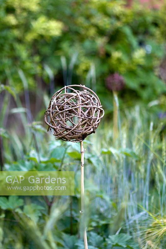 Ornamental garden object made of twisted twigs. Jardin des Pasradis, Cordes-sur-Ciel, Tarn, France.