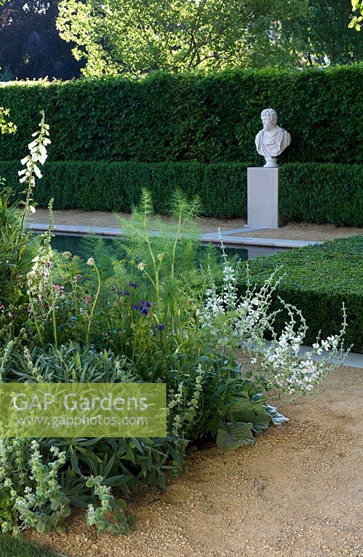 BrandAlley Renaissance garden Bronze medal. Chelsea Flower Show 2014. Italianate garden with long canal pool and classical bust sculpture. Border of foliage planting with fennel. 