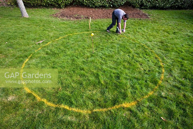 Constructing a circular deck - marking out a deck circle using yellow spray paint