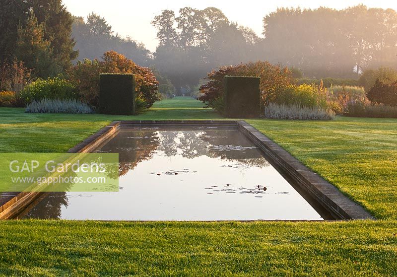 Mist rises off the canal at dawn. Waterperry Gardens, Oxfordshire