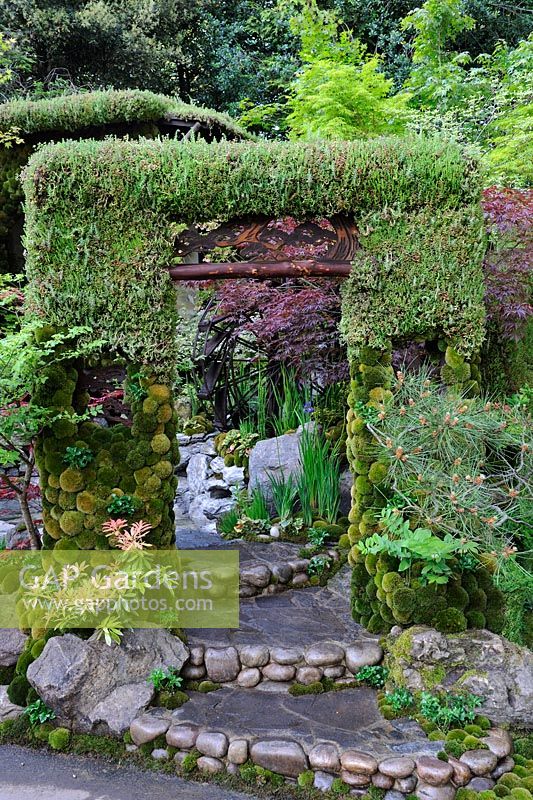 Living arch gate with stone and pebble steps.  Togenkyo - A Paradise on Earth. RHS Chelsea Flower Show 2014