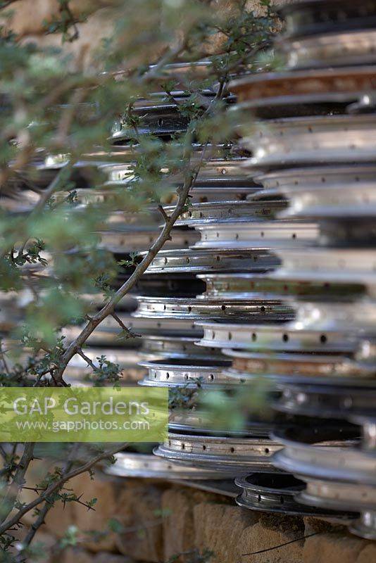 Reclaimed cycle wheels set into stone wall. Tour de Yorkshire, RHS Chelsea Flower Show 2014