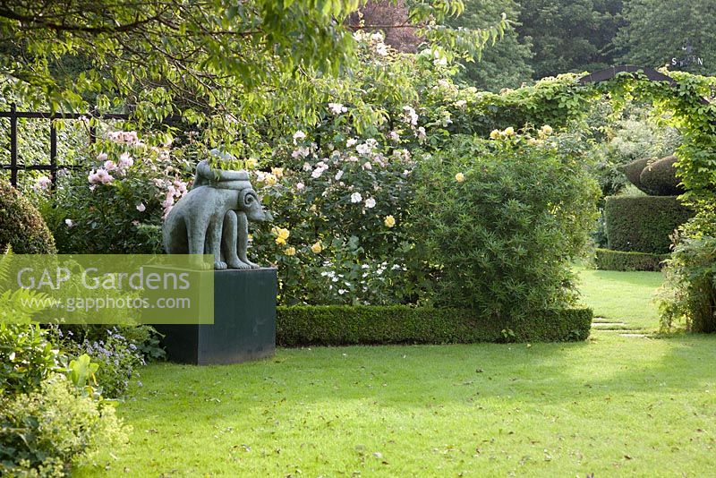 Chenies Manor, Buckinghamshire. Sculpture The Dreamer by Carol Donaldson with Rosa on formal lawn