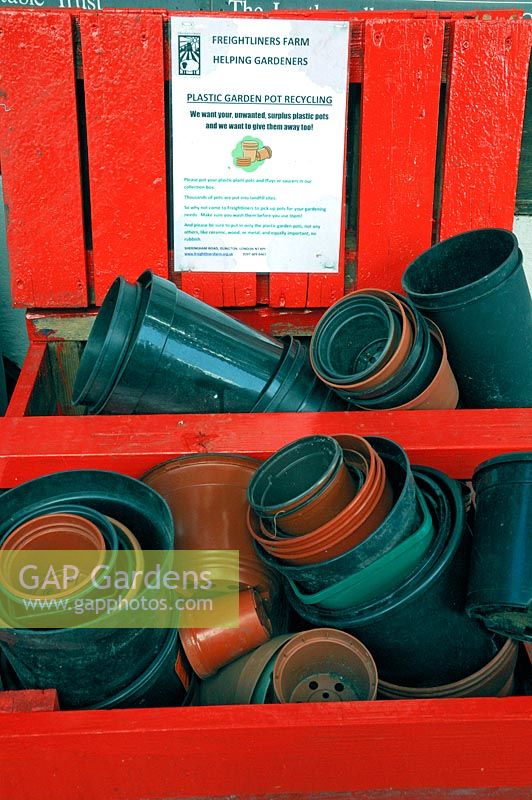 Plastic garden pot recycling at Freightliners Farm, pots recycled in red wooden box, Holloway, London Borough of Islington.