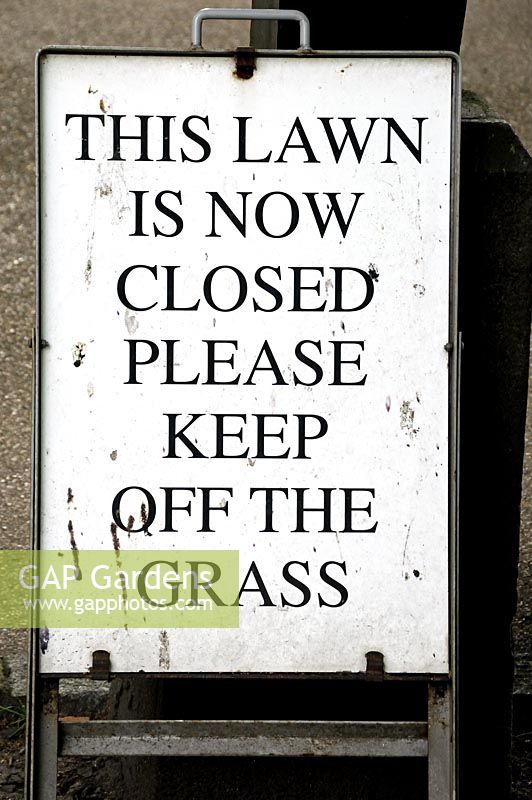 Sign or notice saying - This Lawn is now closed please keep off the grass - London UK