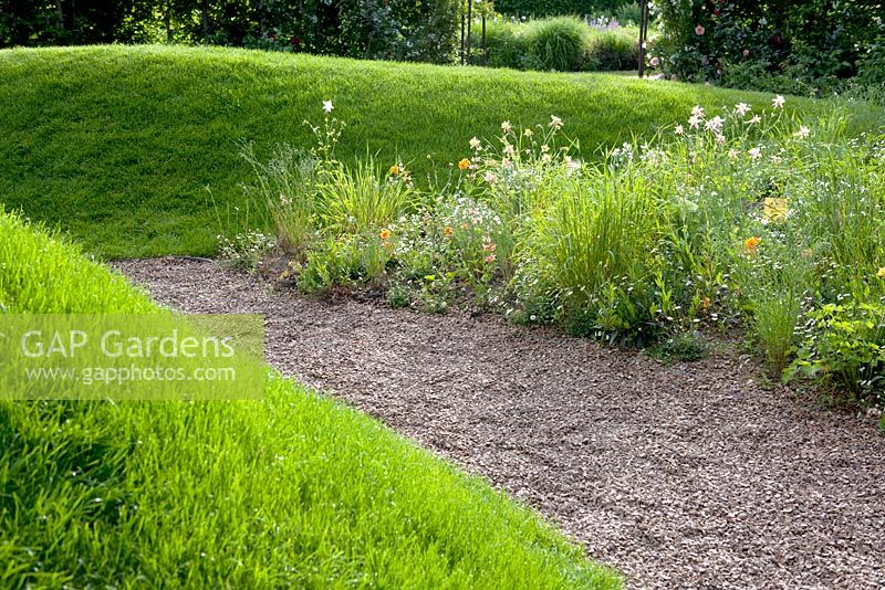 Title: Les Couleurs du Peche.  Two gentle slopes of grass with border of Aquiiegia and Echinacea.