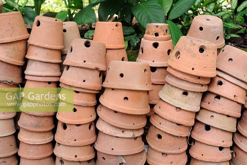 Earthenware pots with holes piled up. 