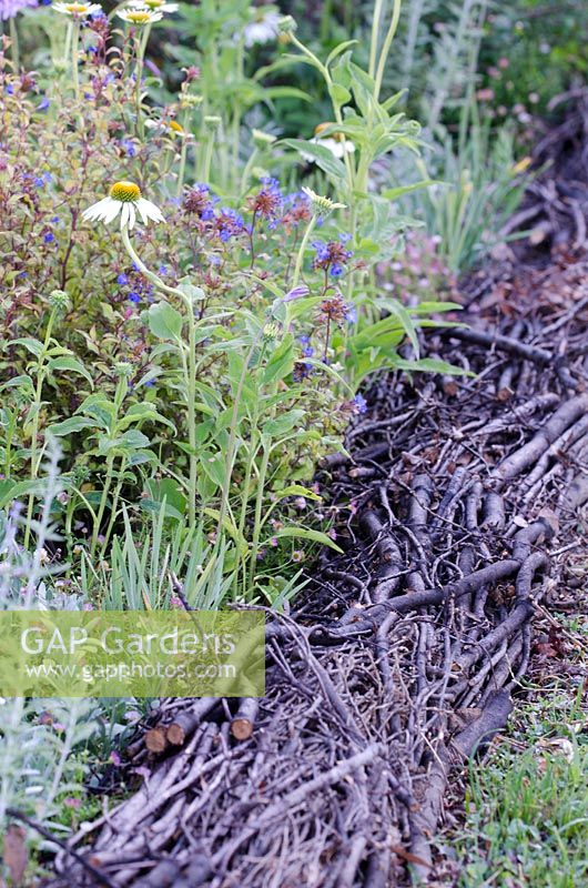 Twigs used for edging a border - Connecting with the Real Sound of Nature, RHS Hampton Court Palace Flower Show 2014 - Design: Stefano Passerotti