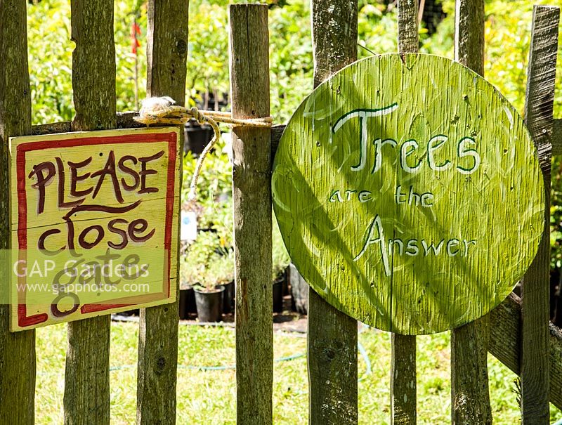 Signs on fence - Please close gate and Trees are the answer 