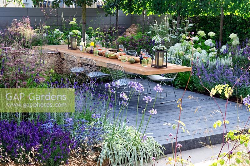 Vestra Wealth's Vista. Dining terrace in a modern contemporary garden showing cantilever ceder table