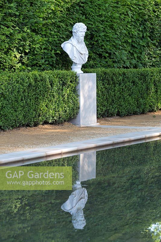 Statue reflected in peaceful pond - The BrandAlley Garden, designer Paul Hervey-Brookes - RHS Chelsea Flower Show 2014

