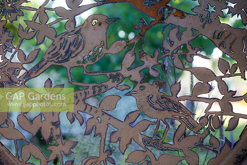 Garden: Metal, A Space to Connect and Grow. Best Summer Garden, gold medal winner. Metalwork birds (thrush, sparrow) hand-carved from recycled materials.