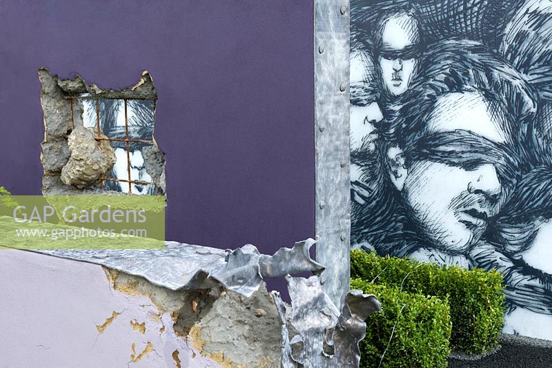 The Stonewall Garden: Breaking Down the Walls of Pride. Conceptual garden wall representing gay pride breaking barriers of old-fashioned beliefs mural on wall representing constraints of prejudice and ignorance. Designer: Amanda Miller Gold award 