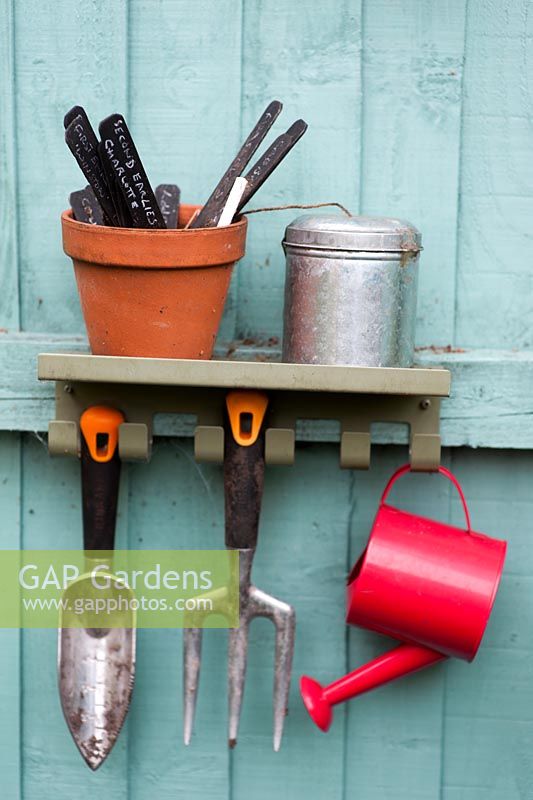 Potting shed tools with child's watering can