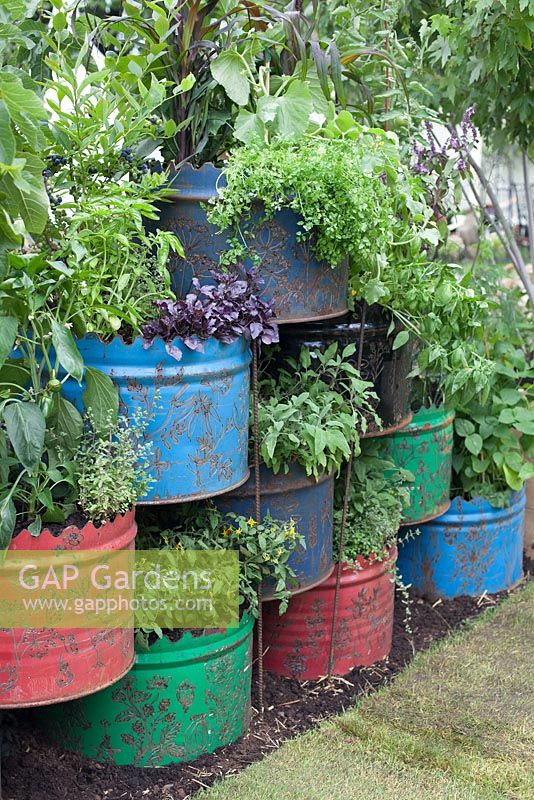 A space to Connect and Grow, recycled industrial materials, such as oil drums planted with vegetables. Designer: Jeni Cairns and Sophie Antonelli - Sponsor: Metal, Earls Scaffolding, British Sugar
