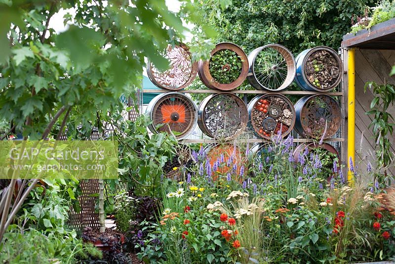A space to Connect and Grow, recycled industrial materials, such as oil drums used as a screen. Designer: Jeni Cairns and Sophie Antonelli - Sponsor: Metal, Earls Scaffolding, British Sugar

