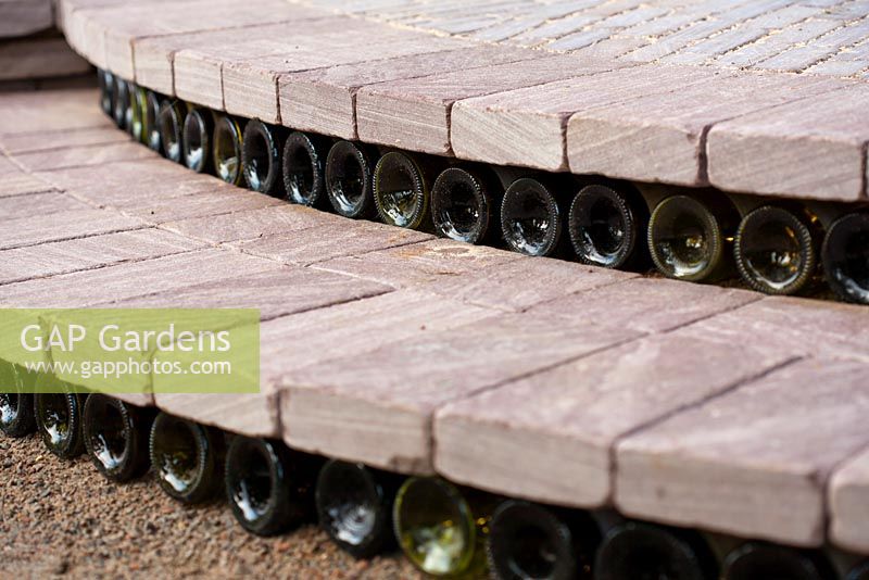 Recycled wine bottles used as risers on stone steps, Bacchus Garden