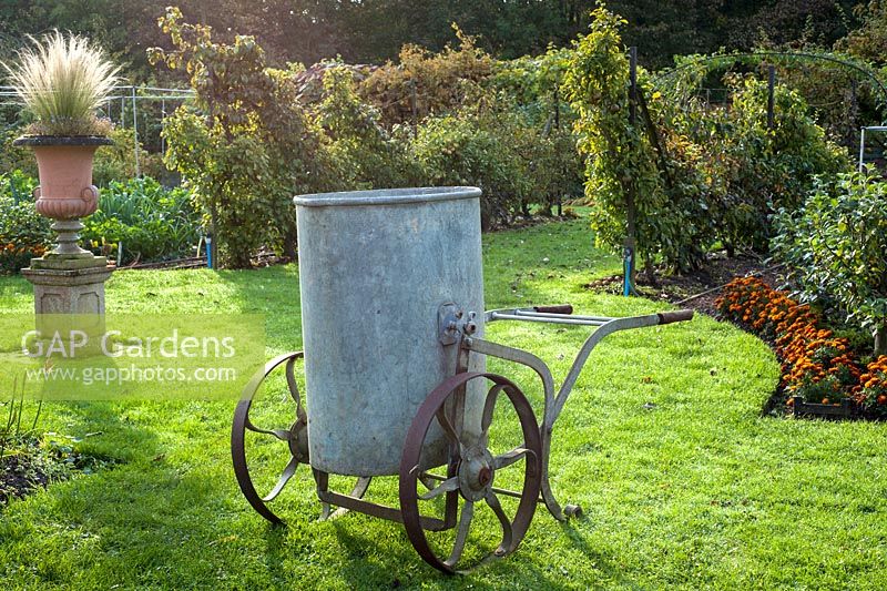 Vintage water carrier with pear espaliers