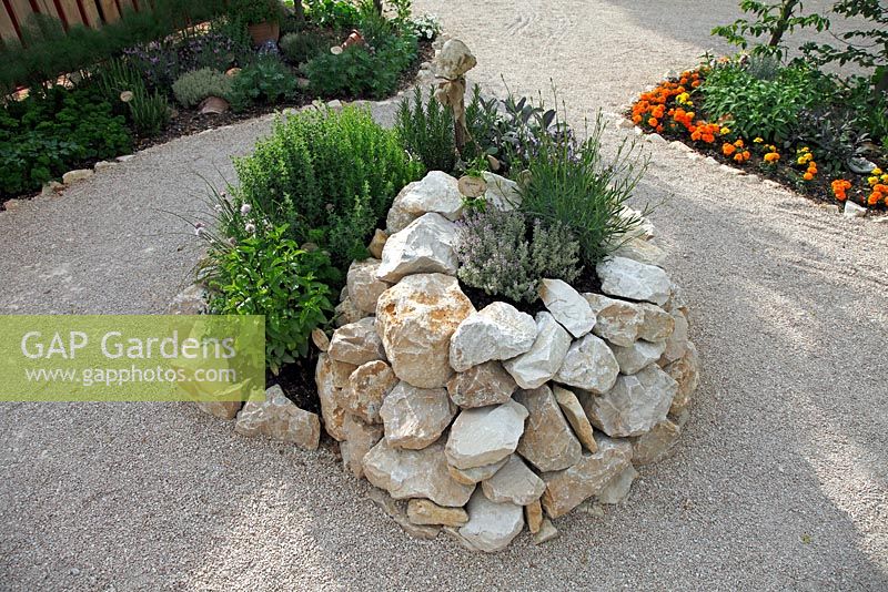 Stone herb spiral planted with herbs, June, Sigmaringen, Germany